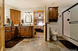 main level master private bath with Jacuzzi tub, separate shower, and dual sinks image 2