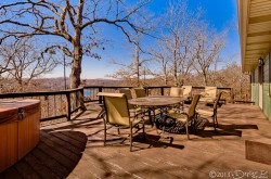 Back deck with deck furniture, outdoor spa, and gas BBQ grill